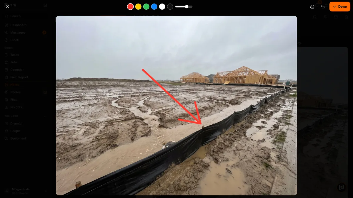 Drawing a red arrow on a photo of a downed silt fence in Parli notes