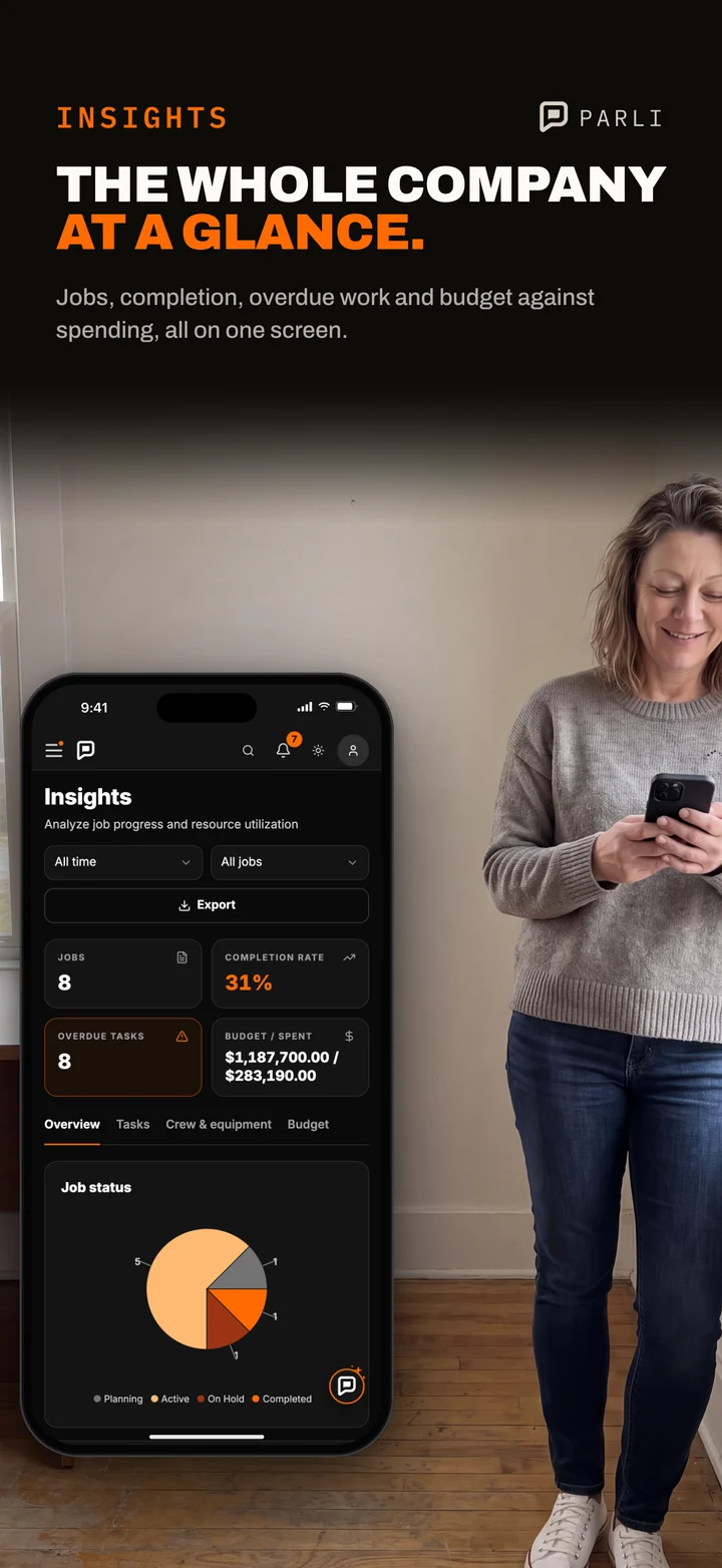 An office manager by the front window checks the Parli Insights overview on her phone