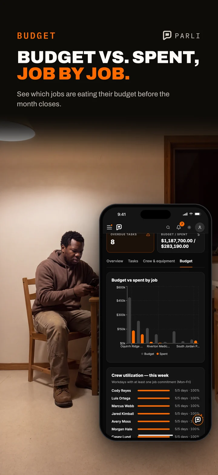A small company owner at his kitchen table at night checks budget against spent by job