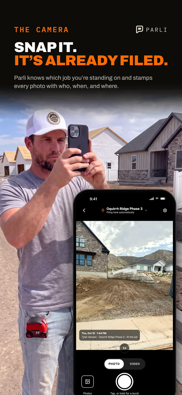 A crew member takes a jobsite photo with the Parli camera, already filing to the job he is at