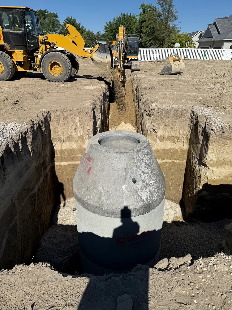 A manhole cone in a sewer trench, ready to draw on