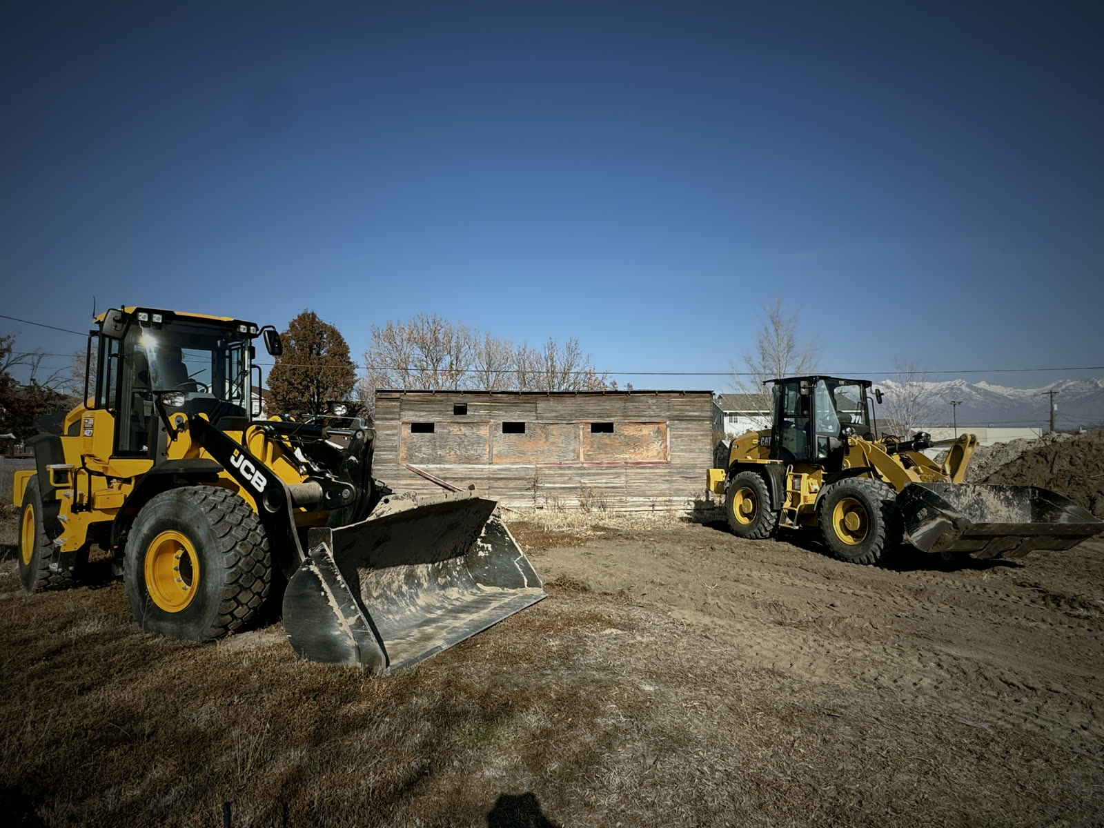 Two Woodward Co. wheel loaders parked at the yard